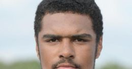 Portrait of a high school football player in a white jersey, showcasing determination and athletic focus at WDHS.