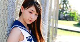 Mizuki dons a classic Japanese school uniform, posing confidently against a fence in sunny outdoor scenery.