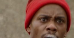 Dave Chappelle in a red beanie, portraying a memorable character from Chappelle's Show Season 2, showcasing intense emotions.