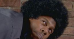 Character from "Chappelle's Show - Season 1," humorously pretending to be hurt while lying on the floor, dramatic expression.