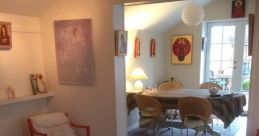 Cozy interior with artwork and inviting dining area, embodying the joy of life and peaceful living—jeg elsker mit liv.