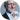 Jeremy Corbyn, prominent British politician, smiling in a formal suit with a blue tie, against a light background.