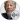 Morgan Freeman with a thoughtful expression, wearing a dark shirt, showcasing his signature gray hair and beard.