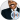 Smiling Steve Harvey in a dark suit with an orange tie, exuding charm and confidence for his fans and followers.