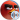 Close-up of Red from The Angry Birds Movie, showcasing his iconic angry expression and vibrant red feathers against a blue sky.