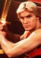 Flash Gordon, wielding a sword, showcases his heroic stance in this iconic sci-fi fantasy scene.