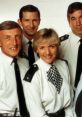 Cast of "The Bill" smiling in uniform, showcasing camaraderie among iconic British police drama characters.