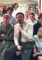 The cast of "The Office (UK)" posing together, showcasing the humorous workplace dynamic and character interactions.