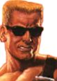 Duke Nukem character, sporting blonde hair and sunglasses, exudes confidence and attitude in a classic gaming style.