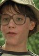 Young boy with glasses and a bucket hat, capturing the essence of youthful innocence in "Lucas" (1986).