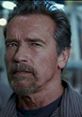 Arnold Schwarzenegger in a tense moment from "Escape Plan," showcasing his intense character in a high-stakes scenario.