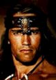 Arnold Schwarzenegger as Conan in "Conan the Destroyer," showcasing a fierce warrior expression and iconic warrior attire.