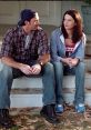 Luke and Lorelai share a moment on the steps, capturing the cozy vibe of "Gilmore Girls - Season 2.