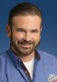 Billy Mays promoting OxiClean with a confident smile, wearing a blue shirt and showcasing the product's logo.