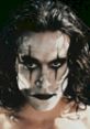 Eric Draven from "The Crow," featuring striking face paint and intense gaze, embodying themes of revenge and resurrection.