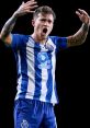 Otávio celebrating passionately in FC Porto jersey, showcasing team spirit and determination in football.