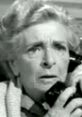 Scared old lady from "The Twilight Zone" reacting in fear while holding a phone, capturing classic horror elements.