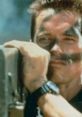 Arnold Schwarzenegger aiming a weapon in "Commando," showcasing intense determination and action-packed moments.