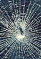 Shattered glass with a web-like crack pattern, illustrating the impact of breaking glass. Perfect for safety discussions.