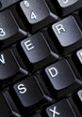 Close-up of a black keyboard showing keys including E, R, S, D, and 4 for enhanced typing efficiency.