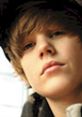 Close-up of Justin Bieber with soft lighting, showcasing his signature hairstyle and thoughtful expression.