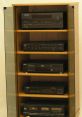 Elegant wooden display cabinet showcasing various audio equipment including CD players and receivers for vintage enthusiasts.