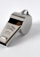 Shiny silver whistle, labeled "The Agni Thunder," made in England. Ideal for sports and coaching activities.