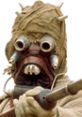 Tusken Raider from Star Wars, armed with a blaster, showcasing distinctive bandages and goggles in a desert setting.