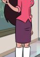 Stylish character from "The Spanish Teacher," wearing a pink blouse and purple skirt, standing in a classroom setting.