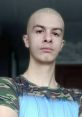 Ivan Zolo, a Russian TikTok blogger, poses confidently in a camo t-shirt, showcasing his unique style and charisma.