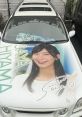 Saya Hiyama's car display featuring her signature and vibrant portrait, showcasing her charm and fan appeal.