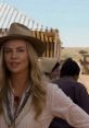 Charlize Theron in "A Million Ways to Die in the West," showcasing the film's Western theme and comedic elements.