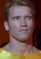 Arnold Schwarzenegger in a tense moment from "The Running Man," showcasing his iconic intense expression and athletic build.