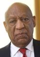 Bill Cosby with a serious expression, wearing a suit and tie, captured during a significant public appearance.