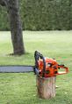 Bright orange chainsaw resting on a wooden stump in a lush green backyard, ready for cutting tasks.