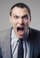 Angry man in a suit yelling with intense expression, showcasing strong emotions and frustration.