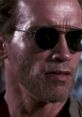 Arnold Schwarzenegger in iconic sunglasses, showcasing his tough character from "Kindergarten Cop" with a serious expression.