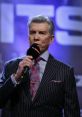 Michael Buffer announces a boxing match, showcasing his signature style and charisma with a microphone in hand.