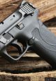 Close-up of M&P M2.0 handgun showcasing grip and trigger, set against a rustic wooden background.