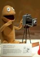 Wilkins and Wontkins puppets from 1979, showcasing Wilkins Coffee's iconic characters with a vintage camera backdrop.