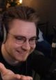 Smiling individual with glasses interacting on a streaming setup, embodying the engaging style of ohnepixel gaming.