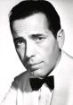 Humphrey Bogart in a classic black and white portrait, showcasing his iconic style and timeless elegance.