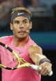 Rafael Nadal in an intense match, showcasing his powerful forehand while wearing a vibrant pink tennis shirt.