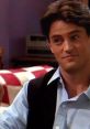 Chandler Bing smirking in a scene, showcasing his iconic humor and style from the classic sitcom Friends.