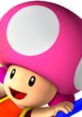 Toadette, featured in Mario Kart: Double Dash, smiles while holding a blue item, showcasing her playful character design.