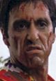 Al Pacino in a tense scene, showcasing intense emotions and dramatic expression, with visible cuts and blood on his face.