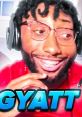 Gyat Kai showcasing excitement with expressive smile, wearing glasses and headset, engaging in dynamic online content.