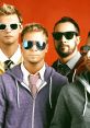 Bsb members posing stylishly in sunglasses against a vibrant red background, showcasing their unique fashion sense.