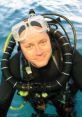 Jonathan Bird in diving gear, smiling underwater, showcasing marine exploration and adventure.