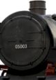 Close-up of a vintage train boiler with a distinctive number, showcasing the intricate design and classic steam engine features.